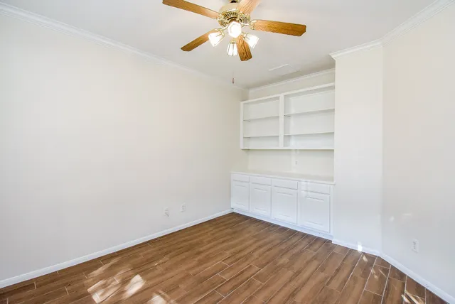a view of an empty room with a window and closet