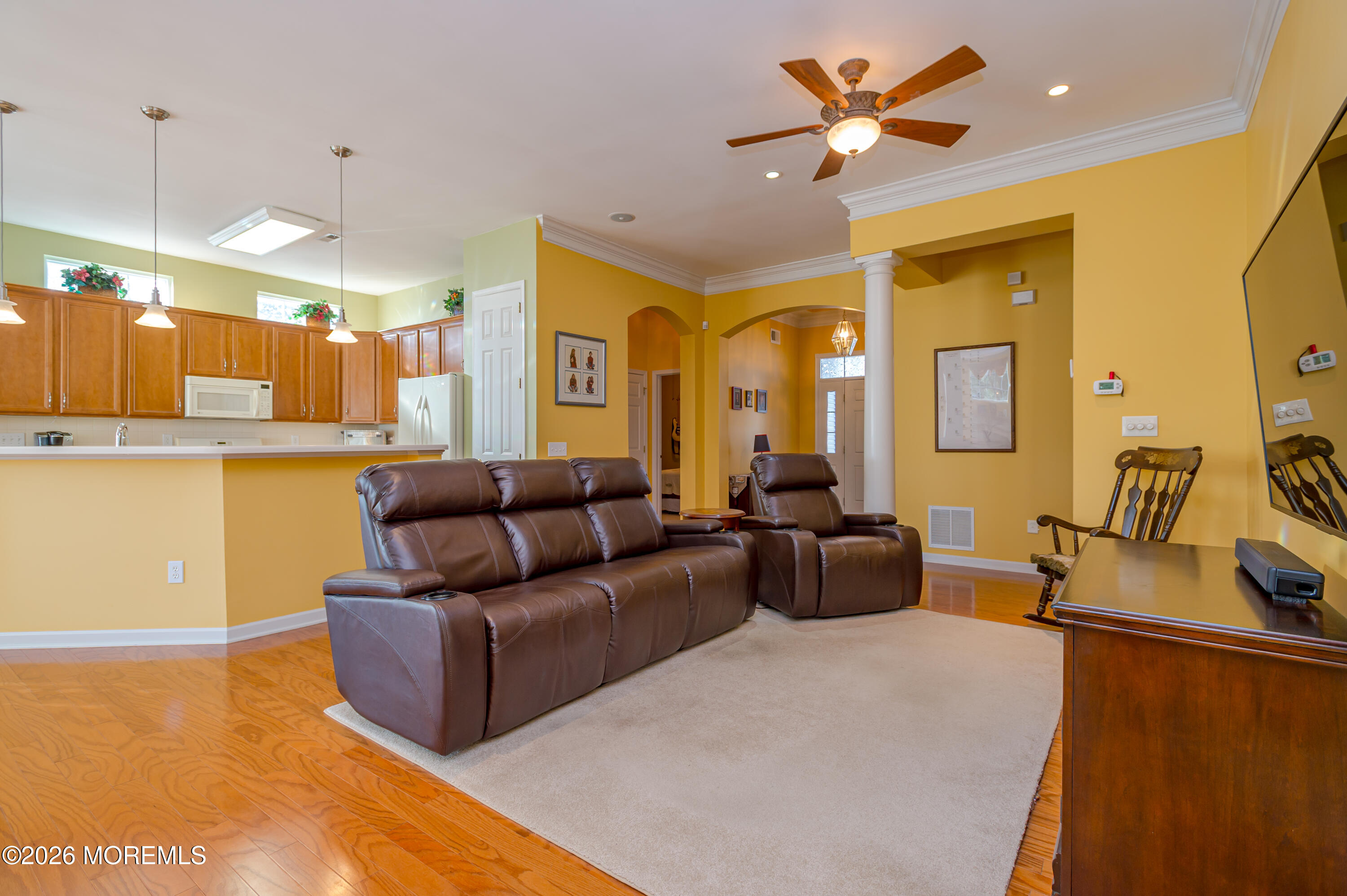 21 Sawgrass Street Jackson, NJ 08527 - Photo 12 of 23 a living room with furniture a flat screen tv and a chandelier