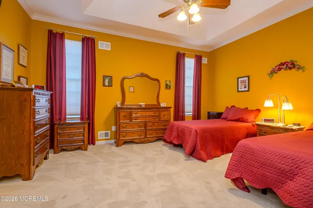 a bedroom with two beds and a chandelier