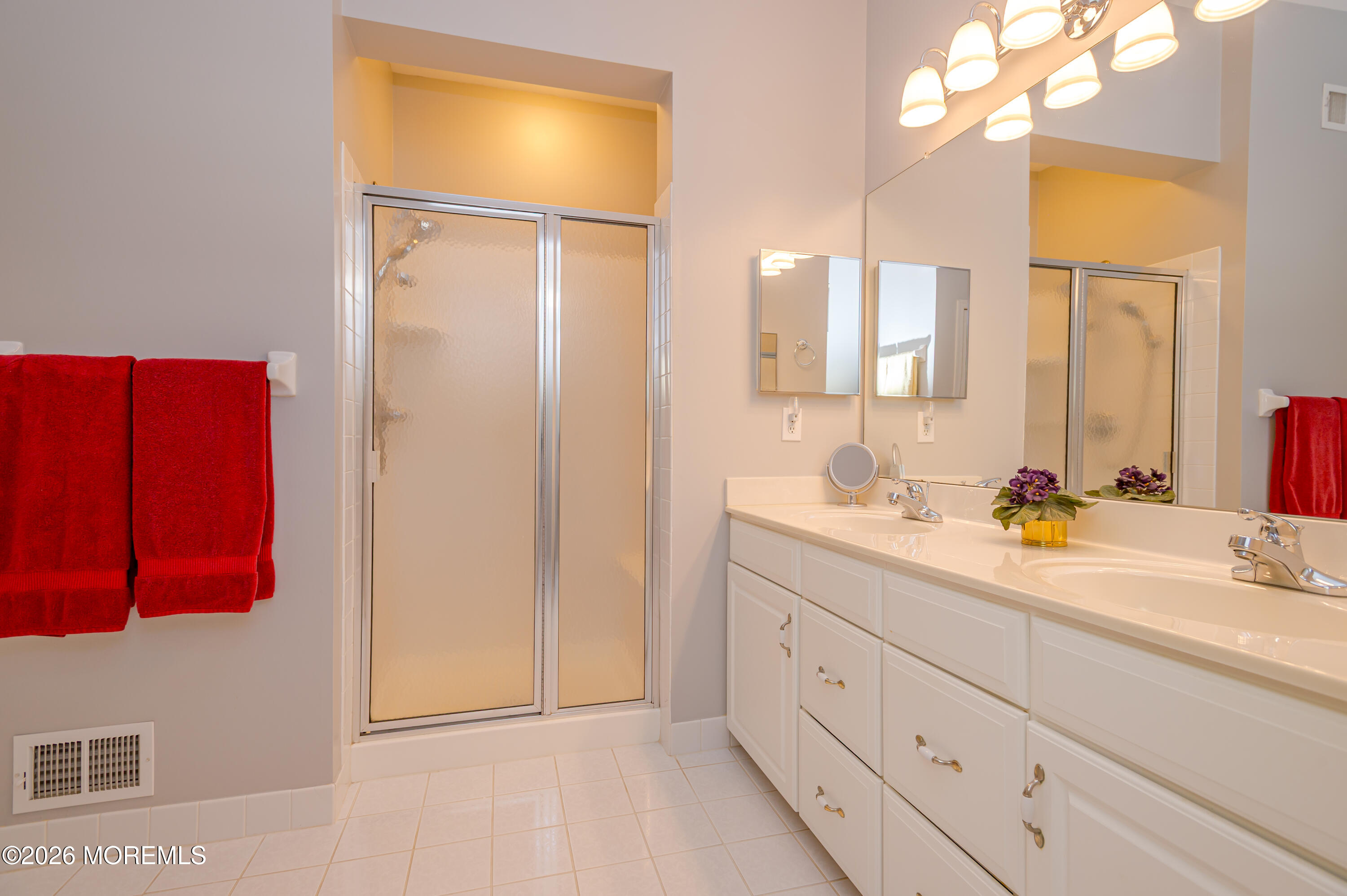 21 Sawgrass Street Jackson, NJ 08527 - Photo 22 of 23 a bathroom with a double vanity sink and mirror