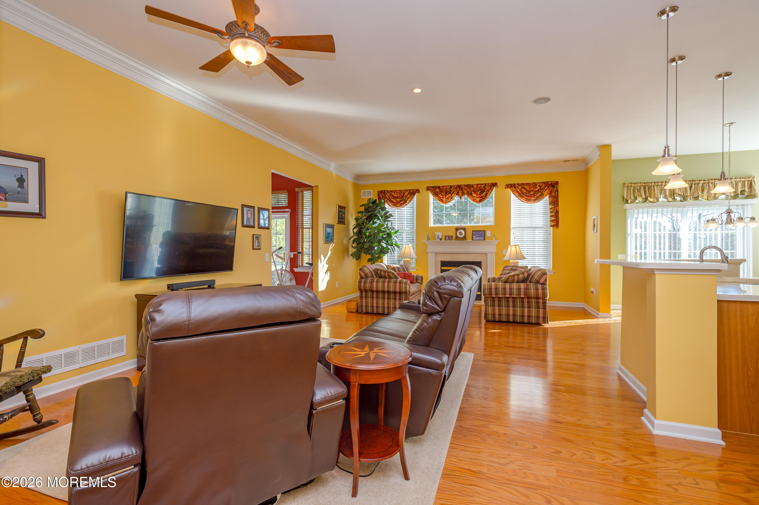 21 Sawgrass Street Jackson, NJ 08527 - Photo 10 of 23 a living room with furniture a flat screen tv and floor to ceiling window