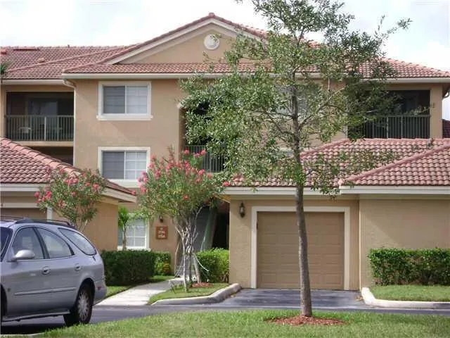 a front view of a house with a garden and plants
