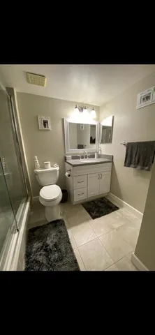 a bathroom with a sink toilet and mirror