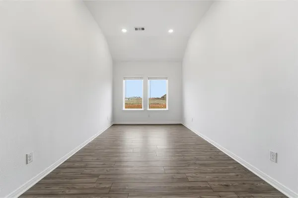 a view of a room with wooden floor and window