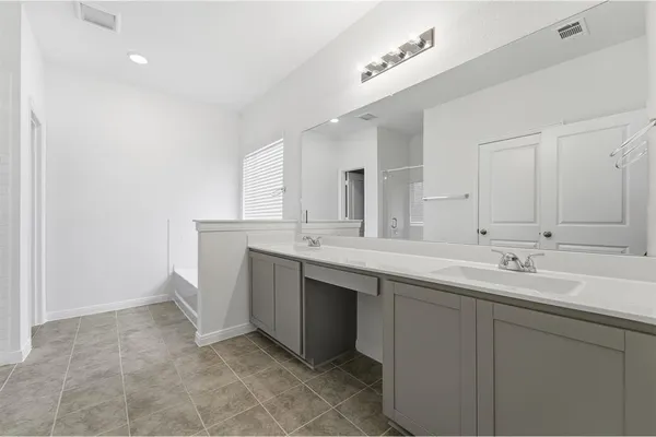 a bathroom with a double vanity sink mirror and