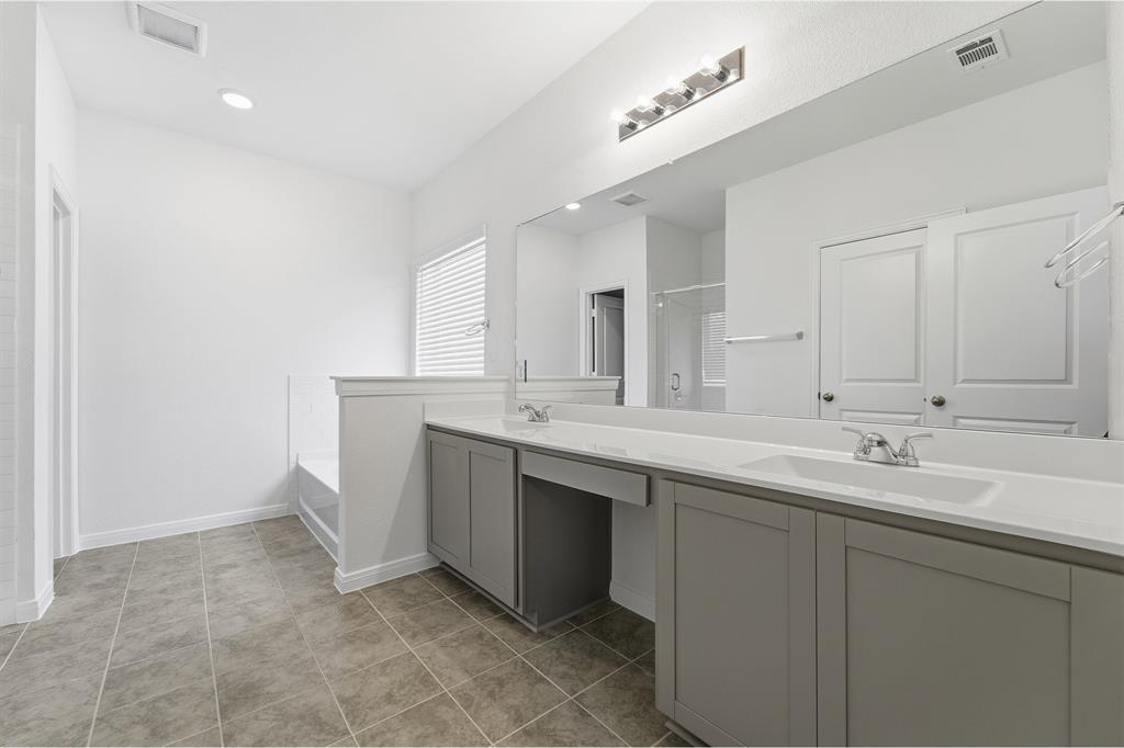 232 Triple Crown Road Waxahachie, TX 75165 - Photo 16 of 22 a bathroom with a double vanity sink mirror and