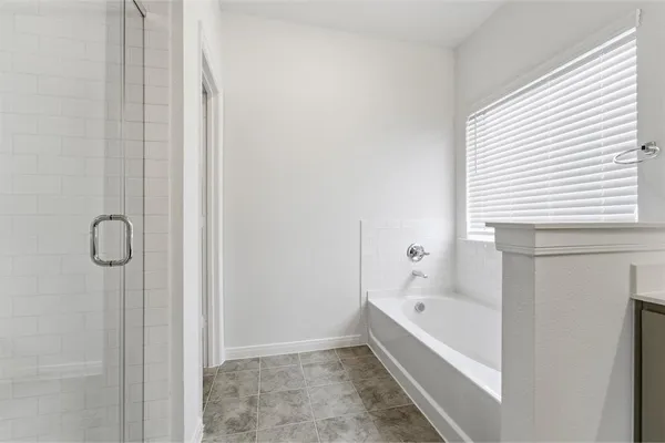 a bathroom with a bathtub and shower