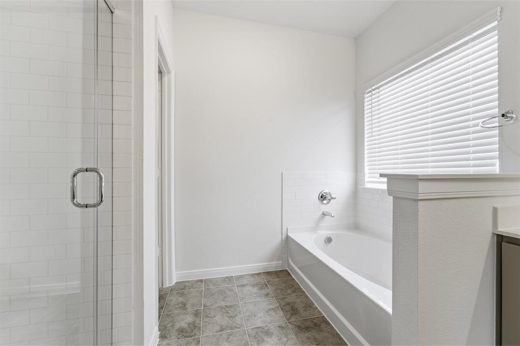 232 Triple Crown Road Waxahachie, TX 75165 - Photo 18 of 22 a bathroom with a bathtub and shower