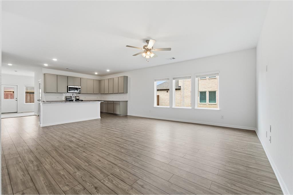 232 Triple Crown Road Waxahachie, TX 75165 - Photo 5 of 22 a view of a kitchen with a sink and a stove top oven