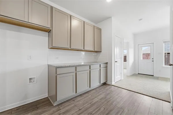 a view of a kitchen with wooden floor