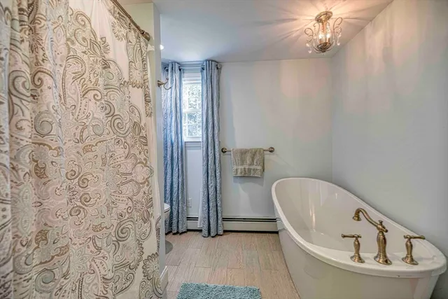 a bathroom with a bathtub and shower