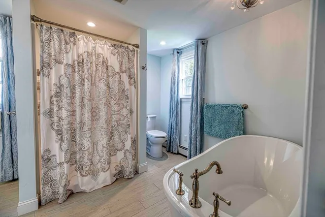 a bathroom with a bathtub and shower