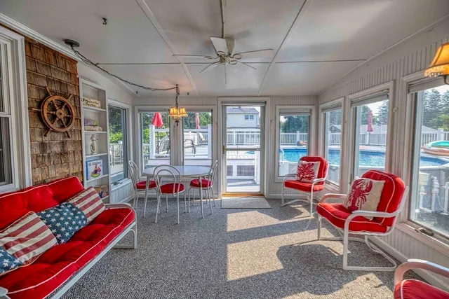 a living room filled with furniture and a potted plant