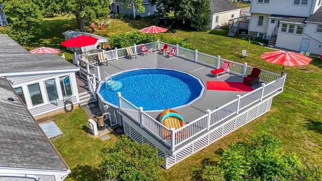 an aerial view of a house roof deck with couches table and chairs potted plants