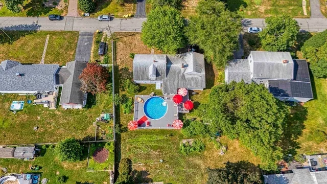an aerial view of residential house with outdoor space and swimming pool
