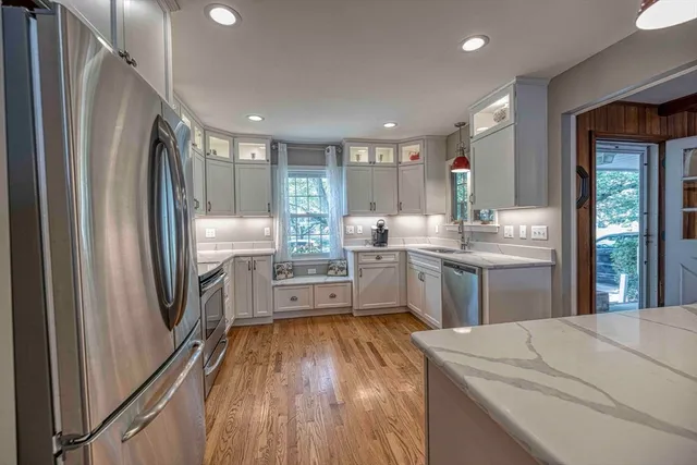a kitchen with refrigerator cabinets and wooden floor