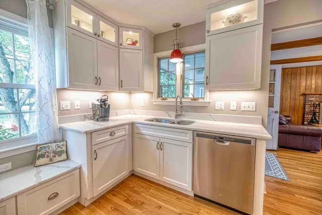 a kitchen with a sink cabinets and window