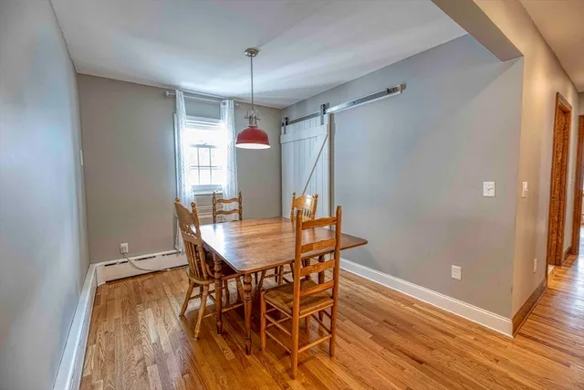 a view of a dining room with furniture window and wooden floor