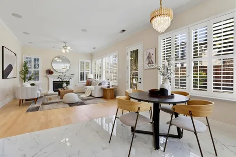 a kitchen with stainless steel appliances kitchen island granite countertop a sink and a white cabinets