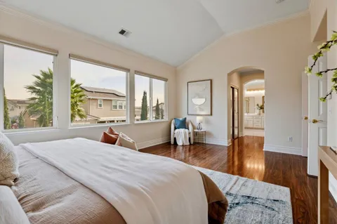 a bedroom with a bed and a mirror