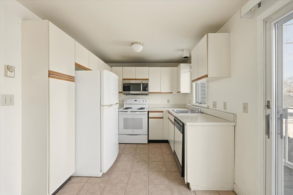 87 Victoria Heights Road, Unit 87 Boston, MA 02136 - Photo 13 of 32 a kitchen with cabinets stainless steel appliances and sink