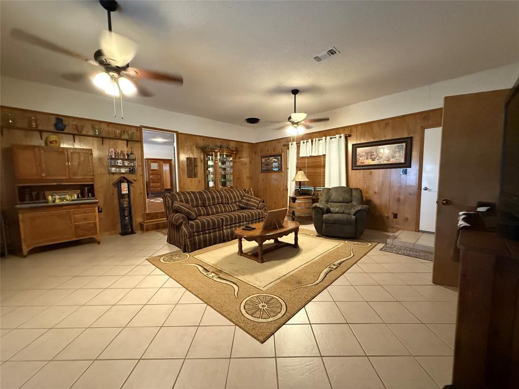 908 North Austin Street Comanche, TX 76442 - Photo 20 of 37 a living room with furniture and a flat screen tv