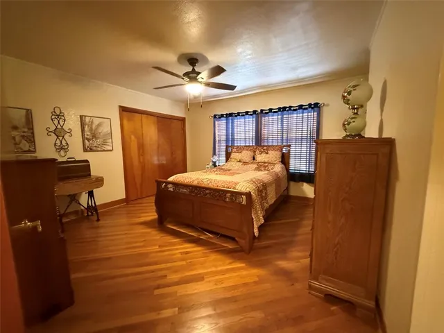 a bedroom with a bed dresser and a window
