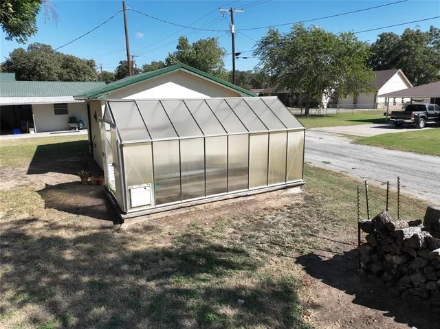 a white and red house with a yard