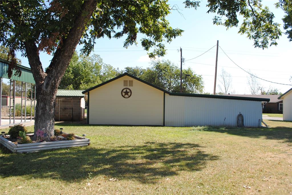 908 North Austin Street Comanche, TX 76442 - Photo 30 of 37 a view of a pool with a yard