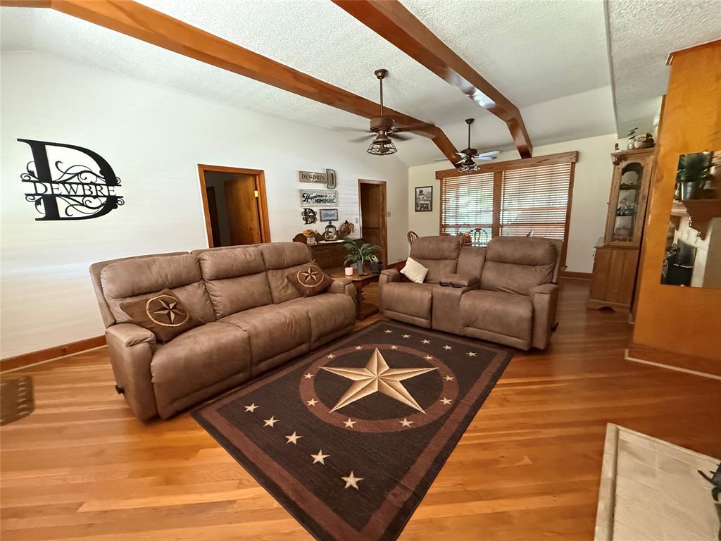 908 North Austin Street Comanche, TX 76442 - Photo 4 of 37 a living room with furniture and a rug