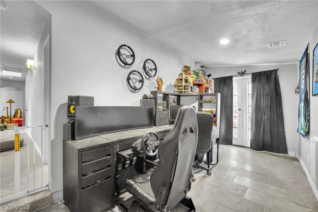 420 North Racetrack Road Henderson, NV 89015 - Photo 36 of 52 A versatile interior space featuring durable tile flooring and access to the outdoors through french doors.