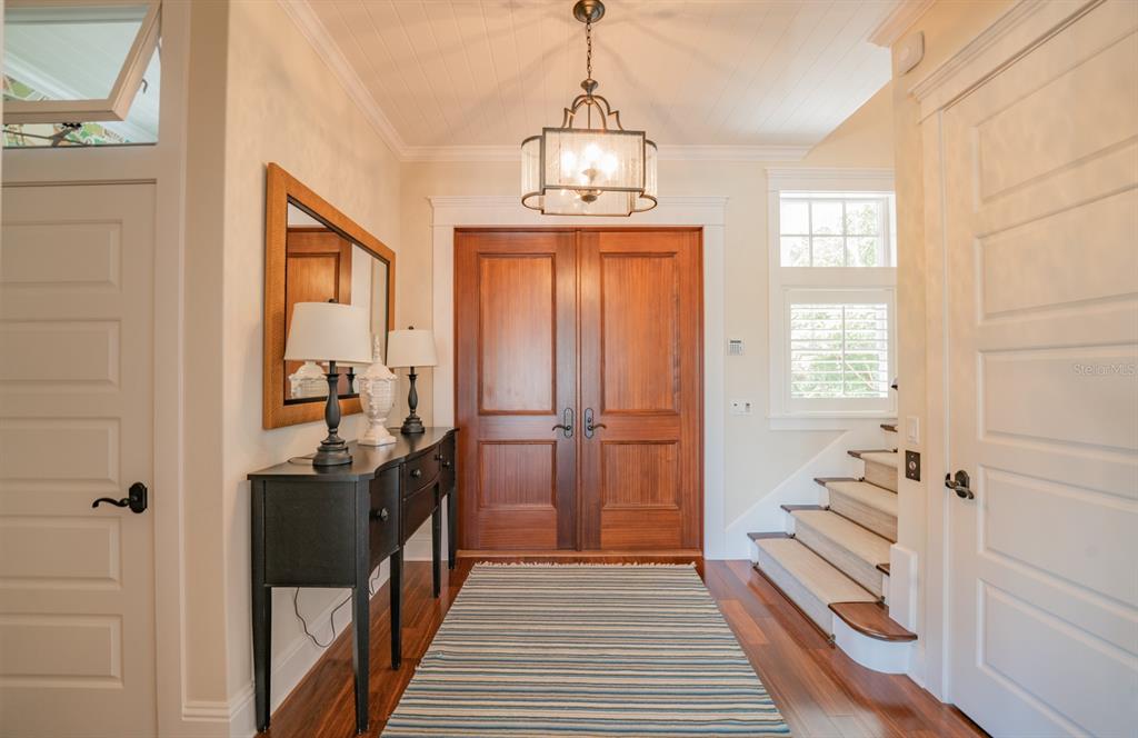 714 Jacaranda Road Anna Maria, FL 34216 - Photo 12 of 100 a view of a hallway view with wooden floor and staircase