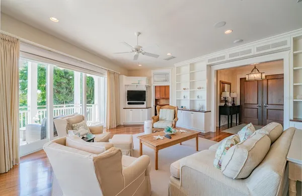 a living room with furniture and a wooden floor