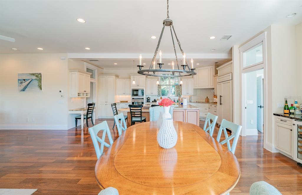 714 Jacaranda Road Anna Maria, FL 34216 - Photo 20 of 100 a dining room filled chandelier and wooden floor