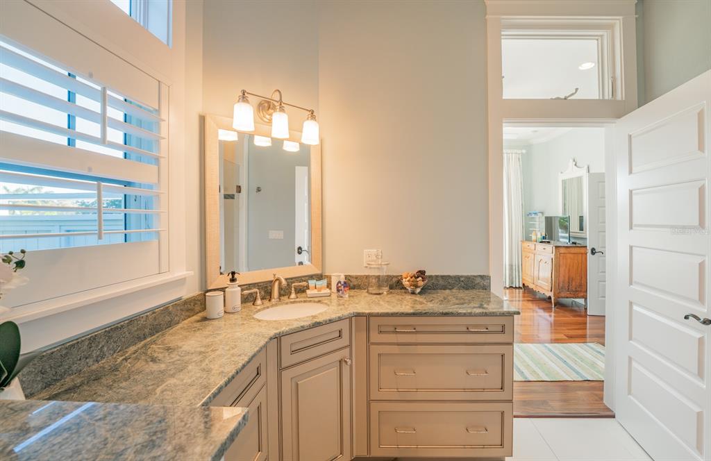 714 Jacaranda Road Anna Maria, FL 34216 - Photo 27 of 100 a bathroom with a sink double vanity and a mirror