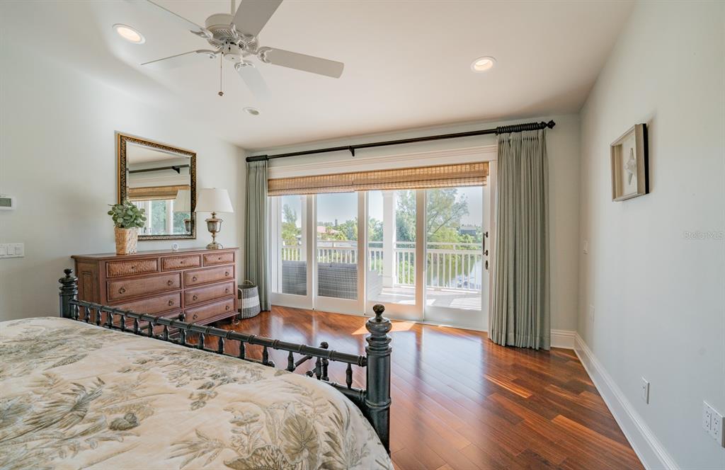 714 Jacaranda Road Anna Maria, FL 34216 - Photo 38 of 100 a bedroom with a bed and wooden floor