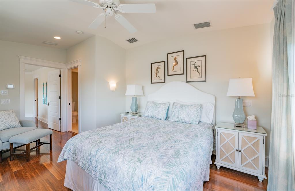 714 Jacaranda Road Anna Maria, FL 34216 - Photo 44 of 100 a bedroom with a bed and a table in it