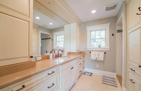 a view of a patio with table and chairs potted plants with floor to ceiling window and garden