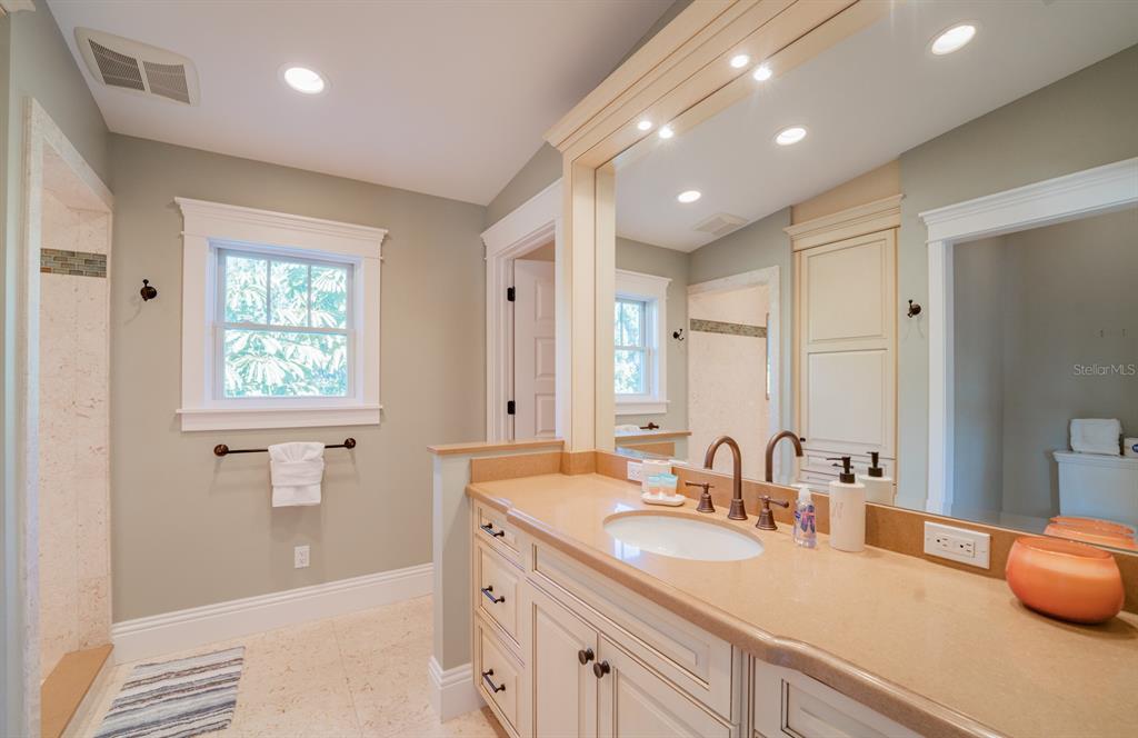 714 Jacaranda Road Anna Maria, FL 34216 - Photo 51 of 100 a bathroom with a double vanity sink and a mirror