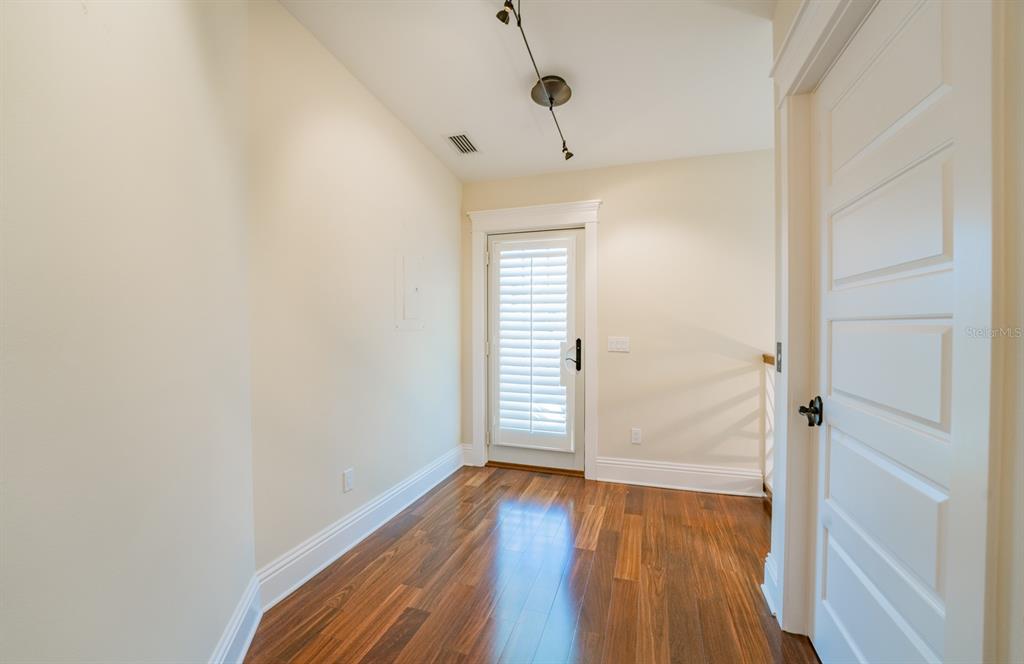 714 Jacaranda Road Anna Maria, FL 34216 - Photo 53 of 100 a view of empty room with wooden floor and fan