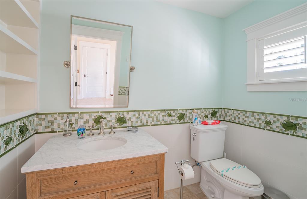 714 Jacaranda Road Anna Maria, FL 34216 - Photo 58 of 100 a bathroom with a sink a toilet and a mirror