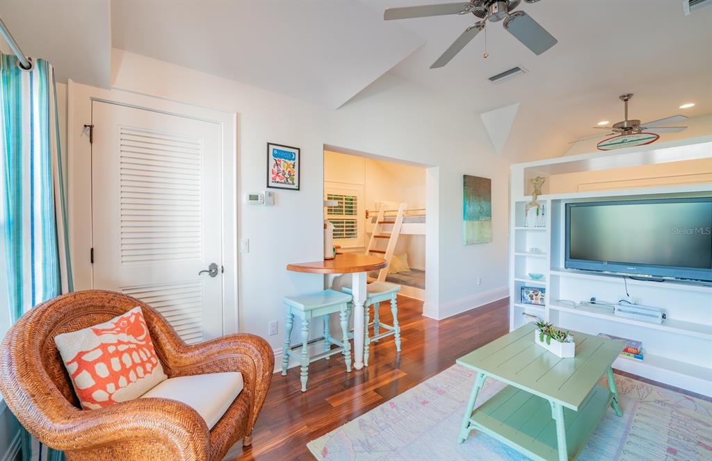 714 Jacaranda Road Anna Maria, FL 34216 - Photo 62 of 100 a living room with furniture a flat screen tv and a large window