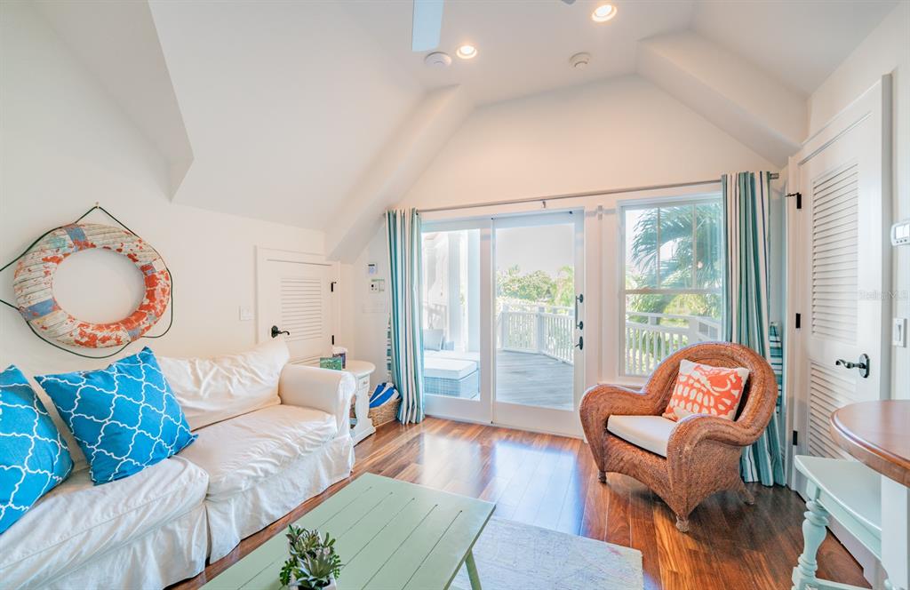 714 Jacaranda Road Anna Maria, FL 34216 - Photo 63 of 100 a living room with furniture and a large window