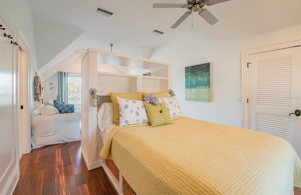 714 Jacaranda Road Anna Maria, FL 34216 - Photo 67 of 100 a bed room with a bed and a chandelier