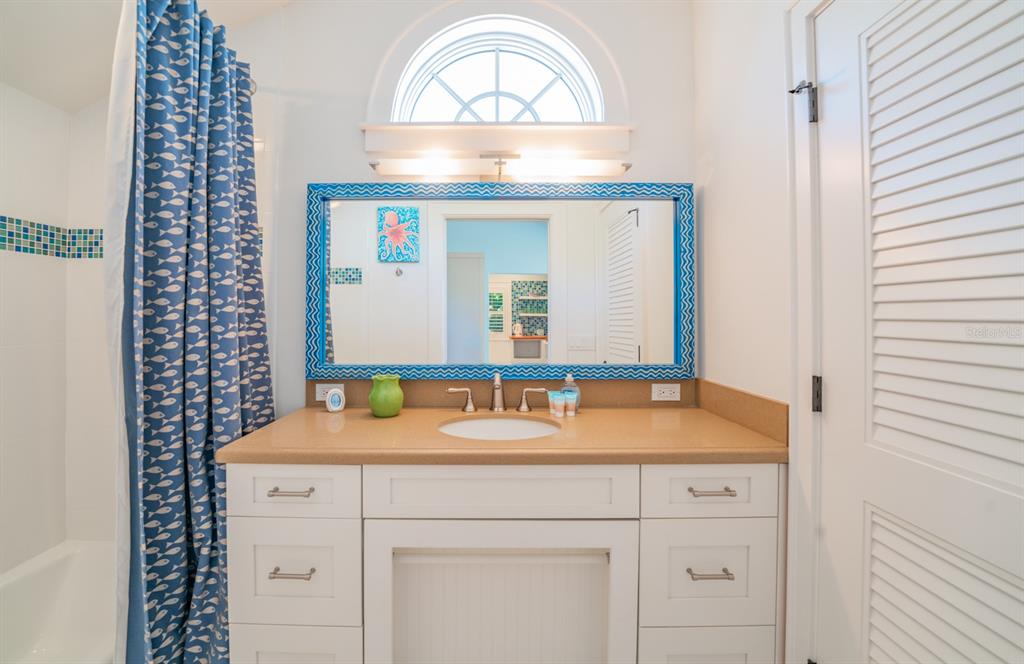 714 Jacaranda Road Anna Maria, FL 34216 - Photo 68 of 100 a bathroom with a sink and a mirror