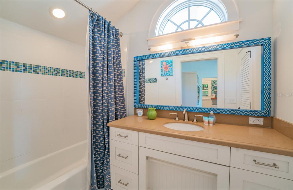 714 Jacaranda Road Anna Maria, FL 34216 - Photo 69 of 100 a bathroom with a sink and a mirror