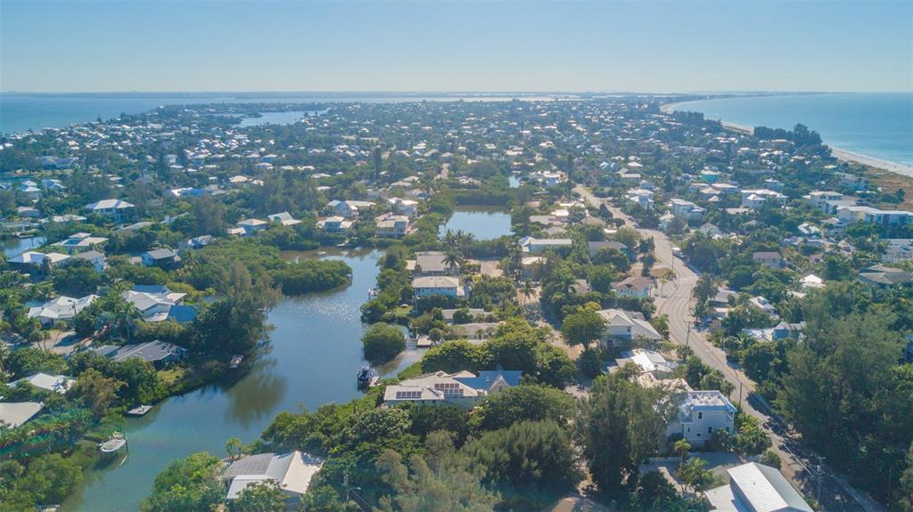 714 Jacaranda Road Anna Maria, FL 34216 - Photo 99 of 100 an aerial view of residential houses with outdoor space and trees