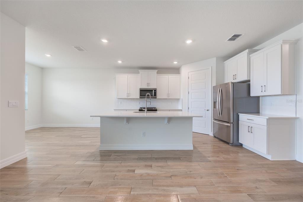 2277 Hamden Way Mount Dora, FL 32757 - Photo 13 of 32 a view of kitchen with granite countertop cabinets and refrigerator