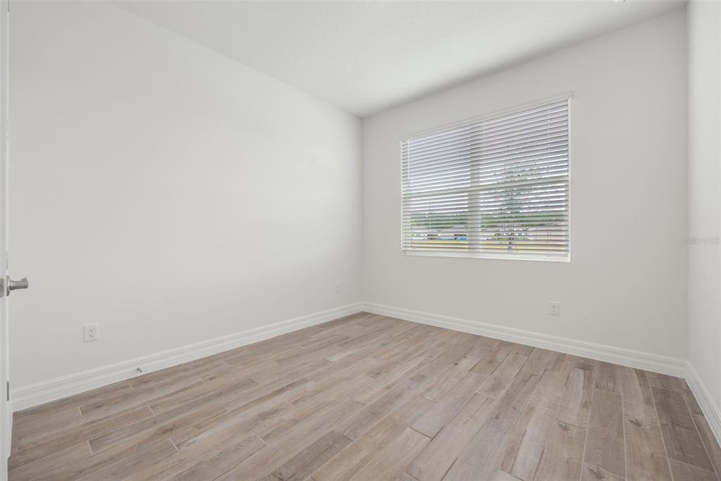 2277 Hamden Way Mount Dora, FL 32757 - Photo 2 of 32 an empty room with wooden floor and windows