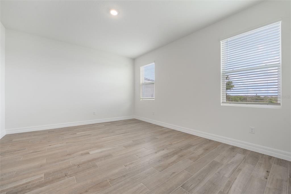 2277 Hamden Way Mount Dora, FL 32757 - Photo 25 of 32 wooden floor in an empty room with a window